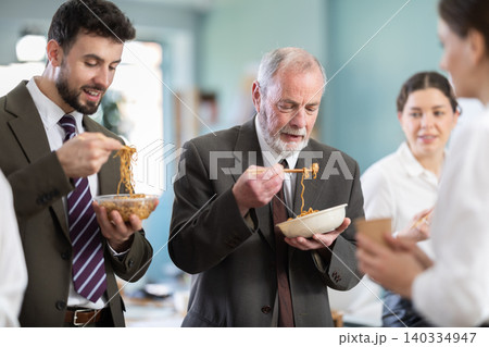 People eat Chinese noodles for lunch People eat Chinese noodles for lunch 140334947