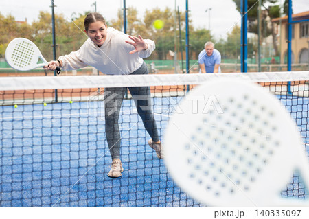 Young girl paddle tennis player performing forehand Young girl paddle tennis player performing forehand 140335097