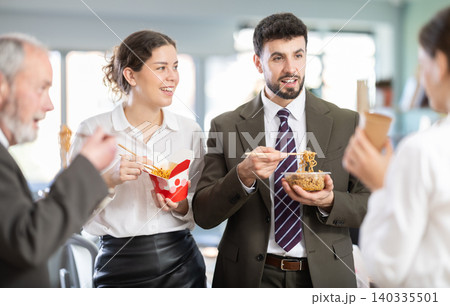 People eat Chinese noodles for lunch People eat Chinese noodles for lunch 140335501