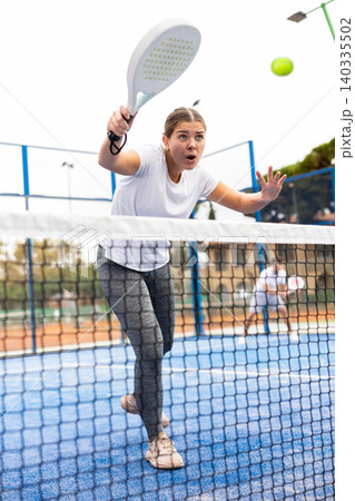 Young sporty woman playing paddle tennis outdoors Young sporty woman playing paddle tennis outdoors 140335502