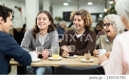 Big friendly family talking over dinner in restaurant 140335792
