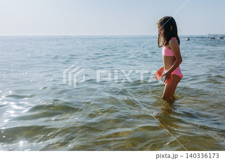 small girl going to swim in the Sea small girl going to swim in the Sea 140336173