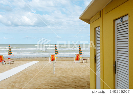 Yellow Beach Cabin with Umbrellas and Sea View 140336207