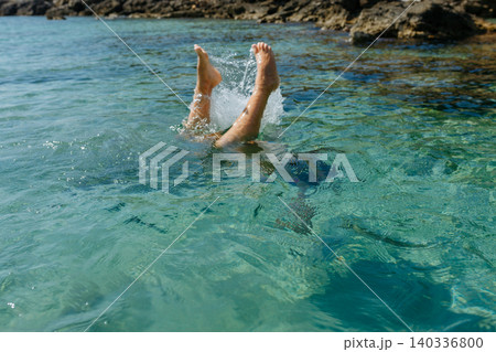 child Diving into Crystal Clear Sea Water During Summer Vacation 140336800