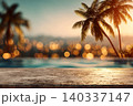 Close-up of a sun-warmed concrete poolside deck with a beautifully blurred infinity pool overlooking a tropical bay at sunset background. 140337147