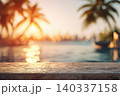 Close-up of a sun-warmed concrete poolside deck with a beautifully blurred infinity pool overlooking a tropical bay at sunset background. 140337158