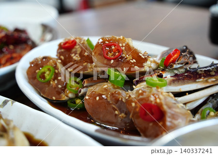 Delicious Korean seafood dish, savory soy sauce marinated crab on a plate Delicious Korean seafood dish, savory soy sauce marinated crab on a plate 140337241