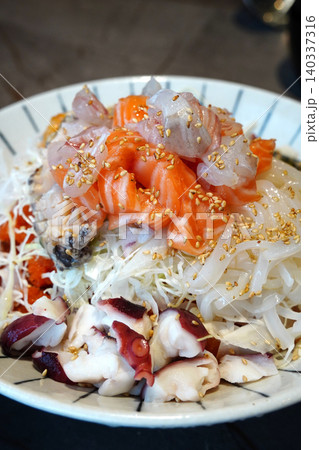Delicious traditional Korean style cold seafood dish served in a large ceramic bowl 140337316