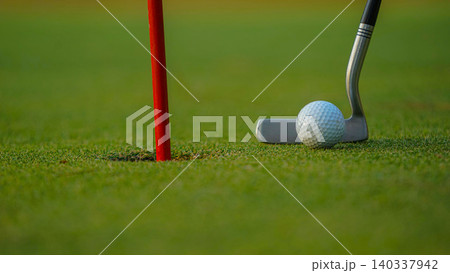 Golf balls on a green lawn in a beautiful golf course with morning sunshine. Golf balls on a green lawn in a beautiful golf course with morning sunshine. 140337942