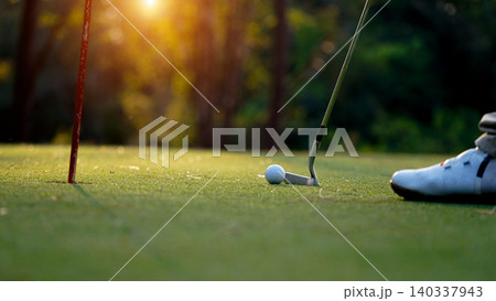 Golfers are putting golf in the evening golf course golf backglound. Golfers are putting golf in the evening golf course golf backglound. 140337943