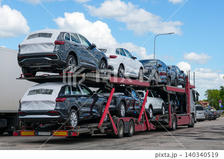 New SUVs transported on car carrier truck during vehicle logistics and automotive distribution New SUVs transported on car carrier truck during vehicle logistics and automotive distribution 140340519