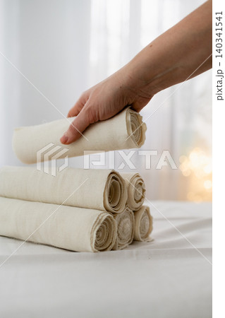 Hand Arranging Rolled Towels For Spa Treatment Hand Arranging Rolled Towels For Spa Treatment 140341541