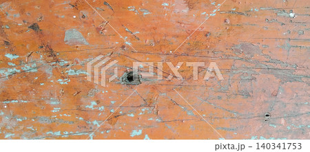 Weathered orange wood surface texture with scratches, peeling paint and natural patterns that give a worn impression. Weathered orange wood surface texture with scratches, peeling paint and natural patterns that give a worn impression. 140341753