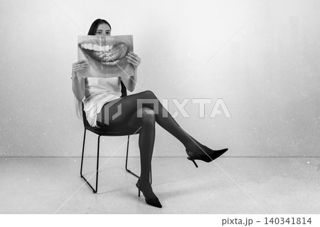 Woman holding magazine with sensual mouth image 140341814