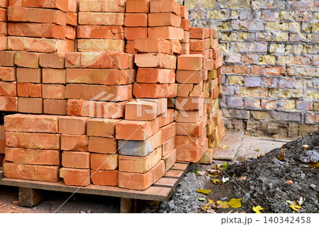 Beginnings.Stacked bricks on a wooden pallet on construction site Beginnings.Stacked bricks on a wooden pallet on construction site 140342458