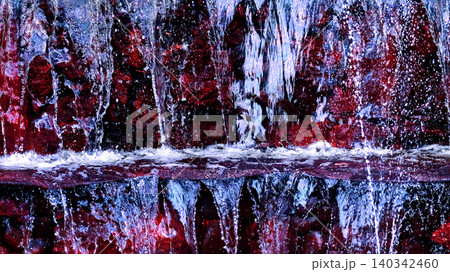 Fresh pure mineral natural water flows over red mountain stones 140342460