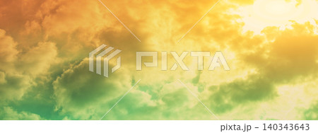 Colorful cloudy sky at sunset. The sun shines through the clouds. Color gradient. The texture of the sky. Abstract natural background. Real photo Not by AI. Horizontal banner 140343643