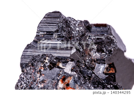 macro mineral stone sherle, schorl, black tourmaline on white background macro mineral stone sherle, schorl, black tourmaline on white background 140344295