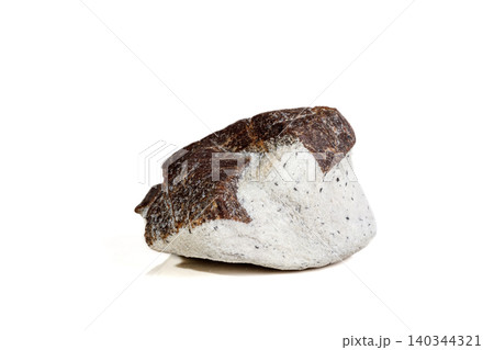 Macro mineral stone Staurolite on a white background Macro mineral stone Staurolite on a white background 140344321