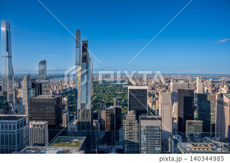 New york, usa august 22,2024. Elevated view revealing the urban sprawl of manhattan with iconic skyscrapers contrasting against the green expanse of central park New york, usa august 22,2024. Elevated view revealing the urban sprawl of manhattan with iconic skyscrapers contrasting against the green expanse of central park 140344985
