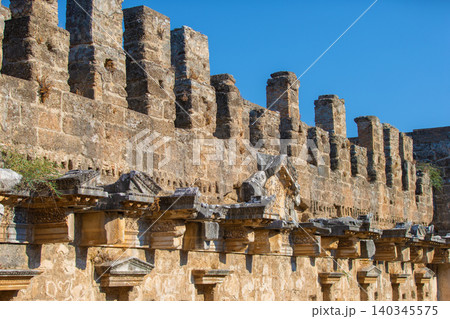 Part of the stone wall of the ancient amphitheater with architectural elements. 140345575