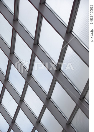 Glass ceiling structure showcasing modern architecture during the day in an urban setting Glass ceiling structure showcasing modern architecture during the day in an urban setting 140345593