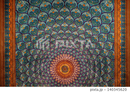 Intricate pattern created by vibrant colors and geometric designs on an ornate ceiling in a historical location Intricate pattern created by vibrant colors and geometric designs on an ornate ceiling in a historical location 140345620