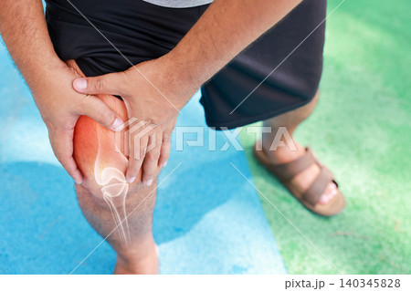 Close up of unrecognizable man suffering from knee joint pain with glowing bone anatomy graphic overlay after rock climbing exercise. Sports injury and medical healthcare concept. Close up of unrecognizable man suffering from knee joint pain with glowing bone anatomy graphic overlay after rock climbing exercise. Sports injury and medical healthcare concept. 140345828