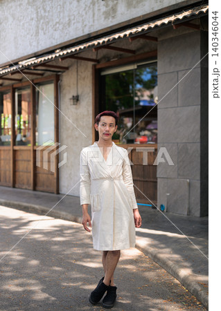 Full Body Portrait of Thai Non-Binary Gay Man Posing Outside Cafe Full Body Portrait of Thai Non-Binary Gay Man Posing Outside Cafe 140346044