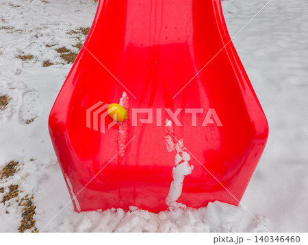 Lemon contrasting bright red slide in winter Lemon contrasting bright red slide in winter 140346460