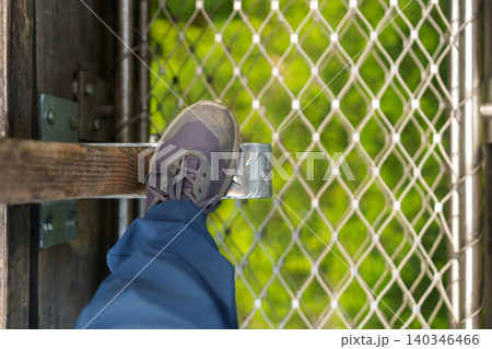Foot stepping on metal platform in treetop adventure park 140346466