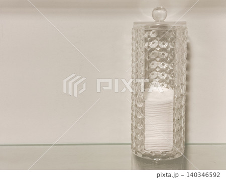 Clear container holding cotton pads for skincare routine Clear container holding cotton pads for skincare routine 140346592