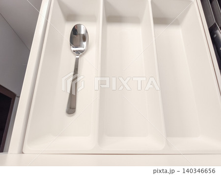 Single spoon in kitchen drawer organizer Single spoon in kitchen drawer organizer 140346656