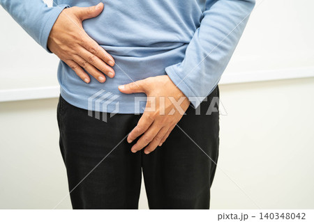 Hernia, Asian man stomach ache, abdominal pain and urology problem health. 140348042