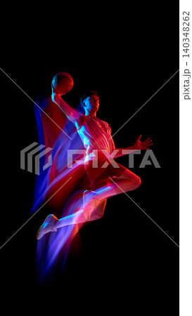 Vertical basketball player jumping with ball and neon motion trails. 140348262