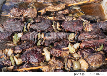 Barbecue veal meat. BBQ grill. Grilled meat on grill. Food and cuisine. Street BBQ food. Cooking beef barbecue meat dish on grill. Backyard barbecue. Braised beef. Veal beef grilled 140348769