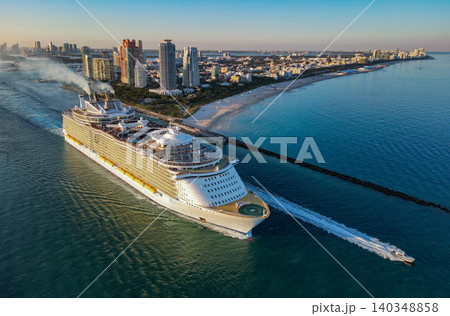 Cruise ship tour and travel at sea. Aerial view of luxury liner voyage. Ship leaving Miami beach port. Miami tour. Cruise ship voyage. Aerial view of cruise in summer vacation 140348858