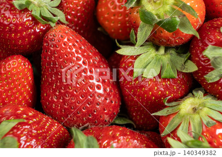 Fresh strawberries with green leaves background Fresh strawberries with green leaves background 140349382