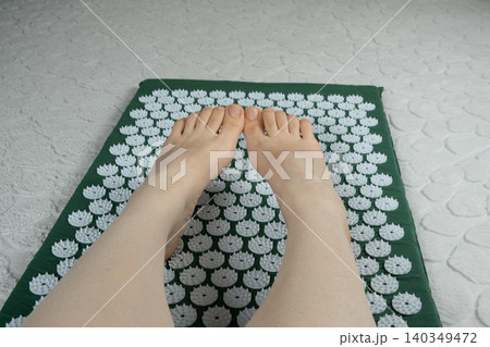 Bare Feet on Acupressure Mat at Home Bare Feet on Acupressure Mat at Home 140349472