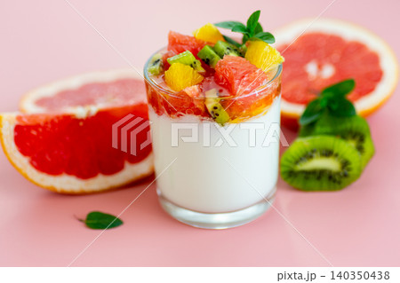 yogurt dessert with tropical fruits and citrus slices on minimal background yogurt dessert with tropical fruits and citrus slices on minimal background 140350438