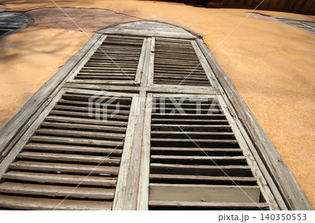 Window with wooden shutters. Old building. Window with wooden shutters. Old building. 140350553