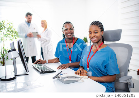 Diverse medical team collaborating in modern clinic office Diverse medical team collaborating in modern clinic office 140351205