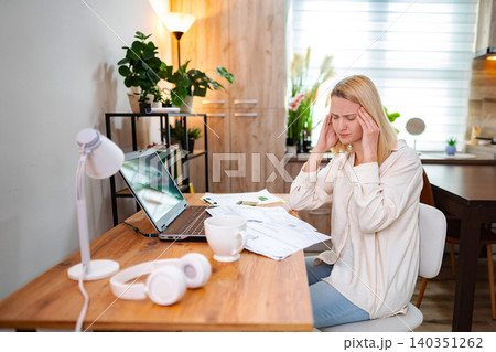 Working from home while feeling overwhelmed in a cozy workspace Working from home while feeling overwhelmed in a cozy workspace 140351262
