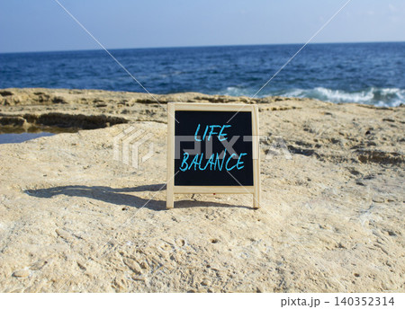 Life Balance symbol. White blackboard with Concept words Life Balance. Beautiful sea background. Business and Life Balance concept. Copy space. Life Balance symbol. White blackboard with Concept words Life Balance. Beautiful sea background. Business and Life Balance concept. Copy space. 140352314