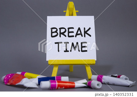 Break Time symbol. Concept word Break Time on wooden blocks. Beautiful grey background with paints and easel. Business and Break Time concept. Copy space 140352331