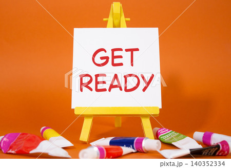 Get ready symbol. Wooden blocks with words Get ready. Beautiful orange background with paints and easel. Business and Get ready concept. Copy space. Get ready symbol. Wooden blocks with words Get ready. Beautiful orange background with paints and easel. Business and Get ready concept. Copy space. 140352334