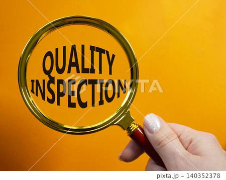 Quality Inspection symbol. Magnifying Glass with words Quality Inspection. Businessman hand. Beautiful orange background. Business and Quality Inspection concept. Copy space. Quality Inspection symbol. Magnifying Glass with words Quality Inspection. Businessman hand. Beautiful orange background. Business and Quality Inspection concept. Copy space. 140352378