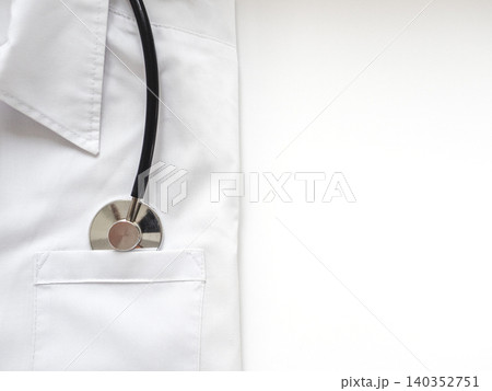 White medical coat with a stethoscope in the pocket White medical coat with a stethoscope in the pocket 140352751