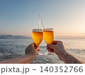 Two hands holding glasses of sparkling wine with straws 140352766