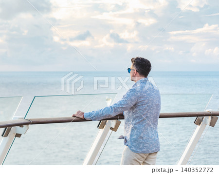Fashionable man standing on the empty deck Fashionable man standing on the empty deck 140352772
